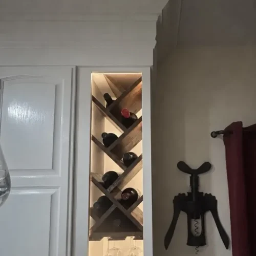 Built-in lighted wine rack and stemware cabinet in the remodeled kitchen